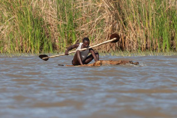 A fisherman clever with his legs out of the water (Lake Chamo)