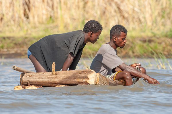 Fishermen with Nile crocodiles around them